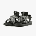 Load image into Gallery viewer, front view of a pair of the all black footwear bowlace sandal
