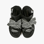 Load image into Gallery viewer, Birdseye view of a pair of the all black footwear bowlace sandal
