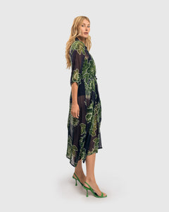 Right side, full body view of a woman wearing the Alembika Royal/Green Ava Chiffon Maxi Dress