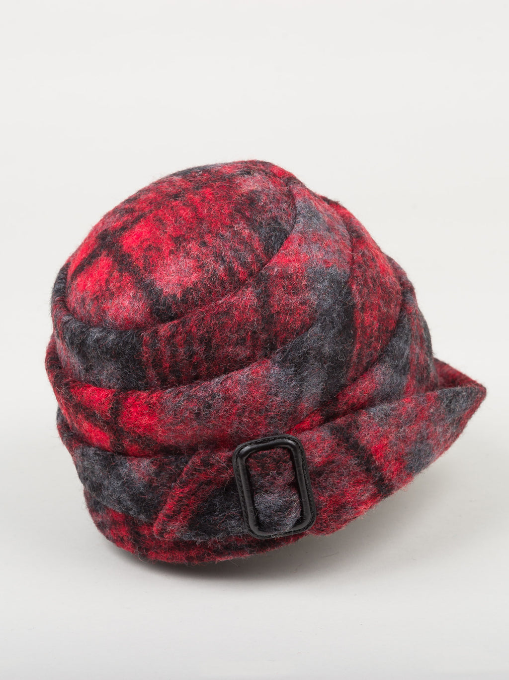 Right side view of a the lillie & cohoe iconic prints lexi hat. This has has red and grey plaid and a tiered/folded crown. The right side of the hat has a decorative black buckle.
