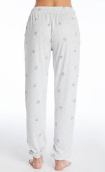 Load image into Gallery viewer, Back bottom half view of a woman wearing the PJ Salvage Lily Rose Banded Pant. The banded pant is a heathered light grey with tiny french bulldog faces printed on it in black.
