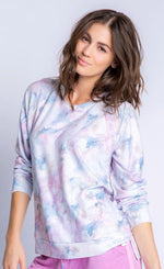 Load image into Gallery viewer, Front top half view of a woman wearing the PJ Salvage Marble top. This top has a soft pink and blue marble print and long sleeves. On the bottom the woman is wearing a pink lounge pant.
