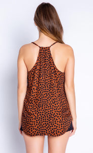 Back view of the top half of a woman wearing the PJ Salvage Wild Love Cami. This cami is mocha/brown colored with a black heart shaped animal print all over it. The back of this tank is a racerback.