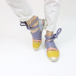 Load image into Gallery viewer, Outer and inner side view of a pair of the papucei etsy shoe. This shoe is flat. The front leather portion that covers the toe is yellow. The strap over the inset is pink and the rest of the shoe leather is purple. This shoe also has purple leather ankle ties.
