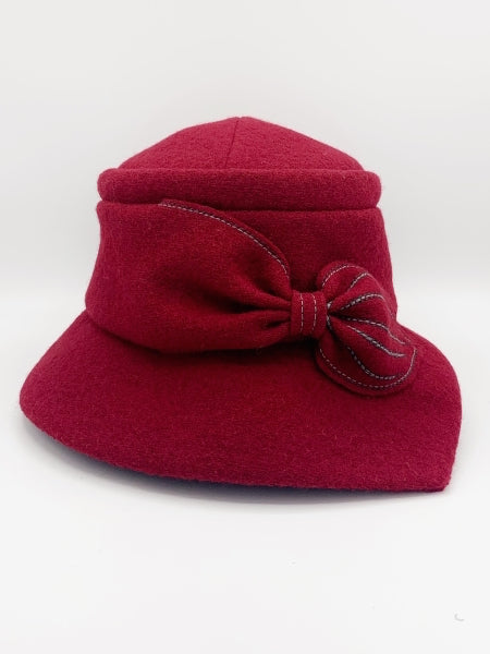 Front view of the lillie & Cohoe grace red/ruby hat. This hat has a pointed brim and a bow  in the front.