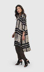 Load image into Gallery viewer, Left side full body view of a woman wearing the alembika savanna adventurer tunic top

