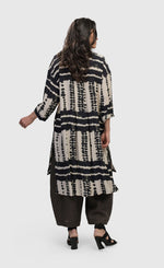 Load image into Gallery viewer, Back full body view of a woman wearing the alembika savanna adventurer tunic top
