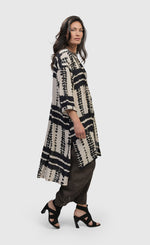 Load image into Gallery viewer, Right side full body view of a woman wearing the alembika savanna adventurer tunic top
