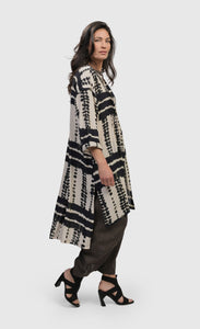 Right side full body view of a woman wearing the alembika savanna adventurer tunic top