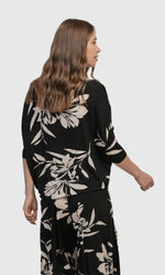 Load image into Gallery viewer, Back top half view of a woman wearing the alembika ciao ciao floral blouson.
