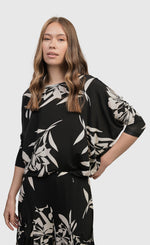 Load image into Gallery viewer, Front top half view of a woman wearing the alembika ciao ciao floral blouson.
