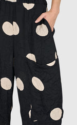 Load image into Gallery viewer, Front close up view of a woman wearing the Alembika Circles Party Pants
