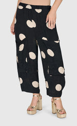 Load image into Gallery viewer, Front bottom half view of a woman wearing the Alembika Circles Party Pants
