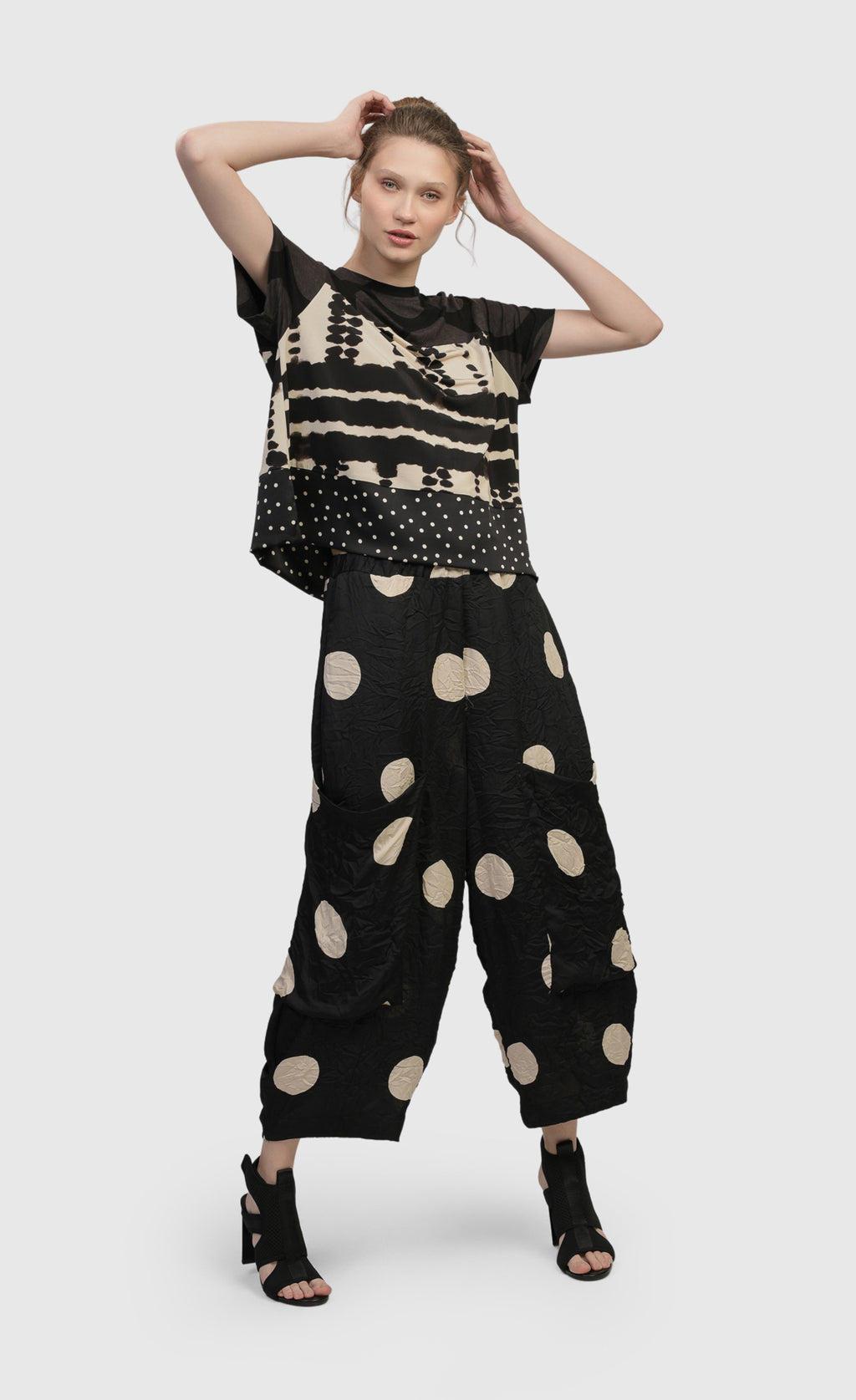 Front full body view of a woman wearing the Alembika Circles Party Pants