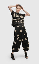 Load image into Gallery viewer, Front full body view of a woman wearing the Alembika Circles Party Pants
