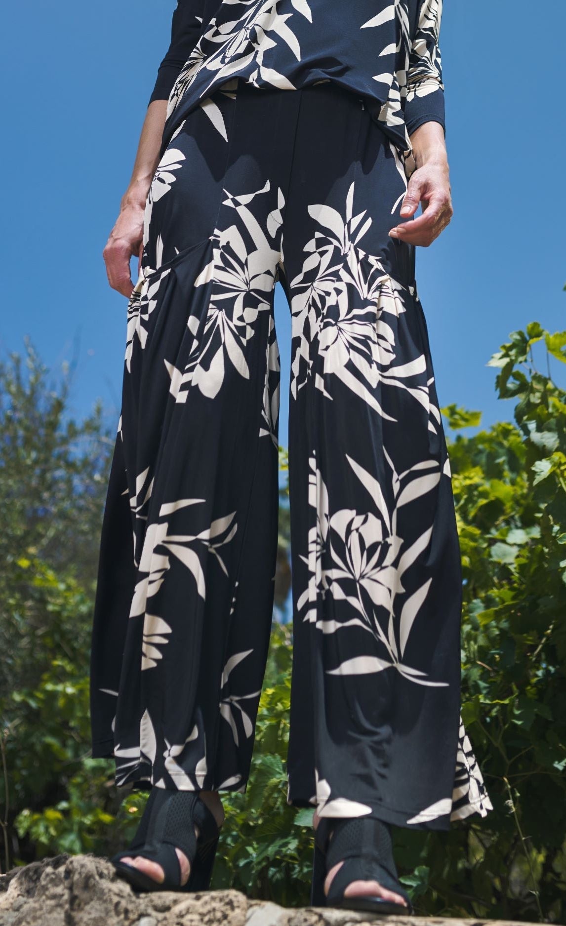 Front bottom half view of a woman wearing the floral bendetta palazzo pants