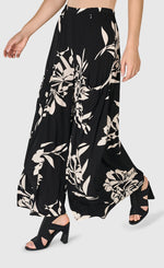 Load image into Gallery viewer, Front bottom half view of a woman wearing the floral bendetta palazzo pants
