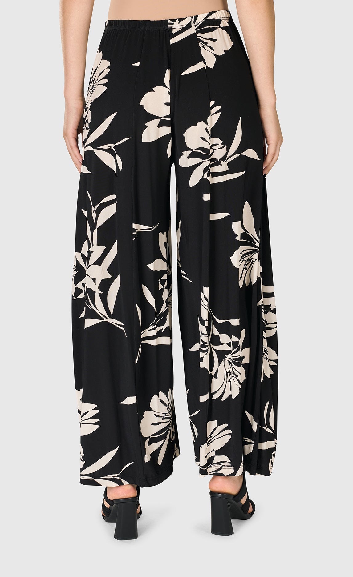 Back bottom half view of a woman wearing the floral bendetta palazzo pants