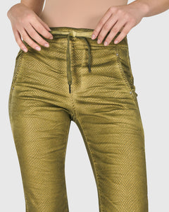 Alembika close up view of a woman wearing the alembika iconic stretch jeans in green snake.