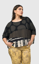 Load image into Gallery viewer, Front top half view of a woman wearing the Alembika Izma Boxy Tee.
