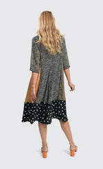 Load image into Gallery viewer, Back full body view of a woman wearing the alembika meredith trapeze shirtdress. 
