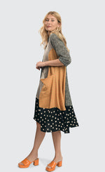 Load image into Gallery viewer, Left side full body view of a woman wearing the alembika meredith trapeze shirtdress. 
