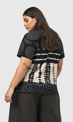 Load image into Gallery viewer, Back top half view of a woman wearing the Alembika Savanna Mountaineer Tee
