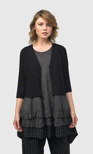 Front top half view of a woman wearing the alembika striped andromeda cropped cardigan