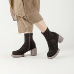 Load image into Gallery viewer, Side view of a person wearing the all black footwear mod stretch bootie in black and grey
