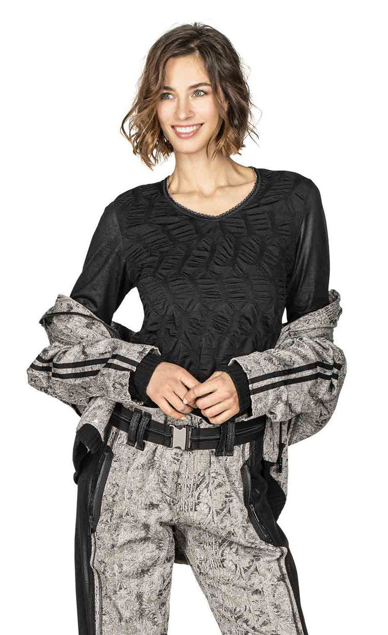 Front top half view of a woman wearing the beate heymann black bubble top