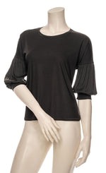 Load image into Gallery viewer, Front top half view of a mannequin wearing the black half sleeve blouse.
