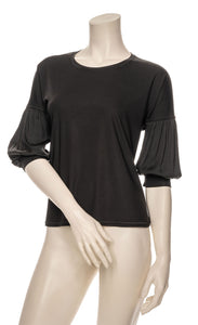 Front top half view of a mannequin wearing the black half sleeve blouse.