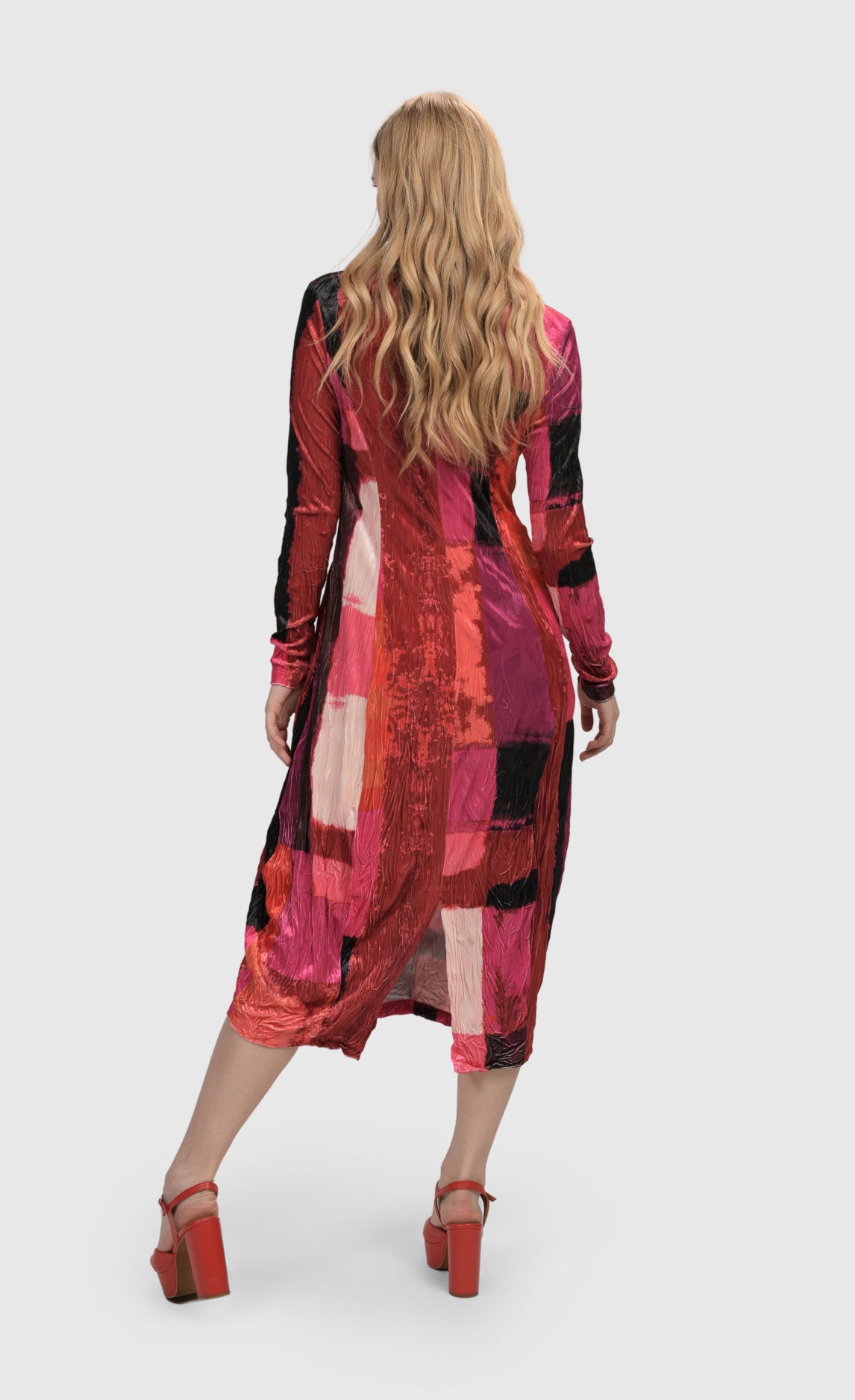 Back full body view of a woman wearing the Alembika Sunset Strip Cocoon Magenta Dress