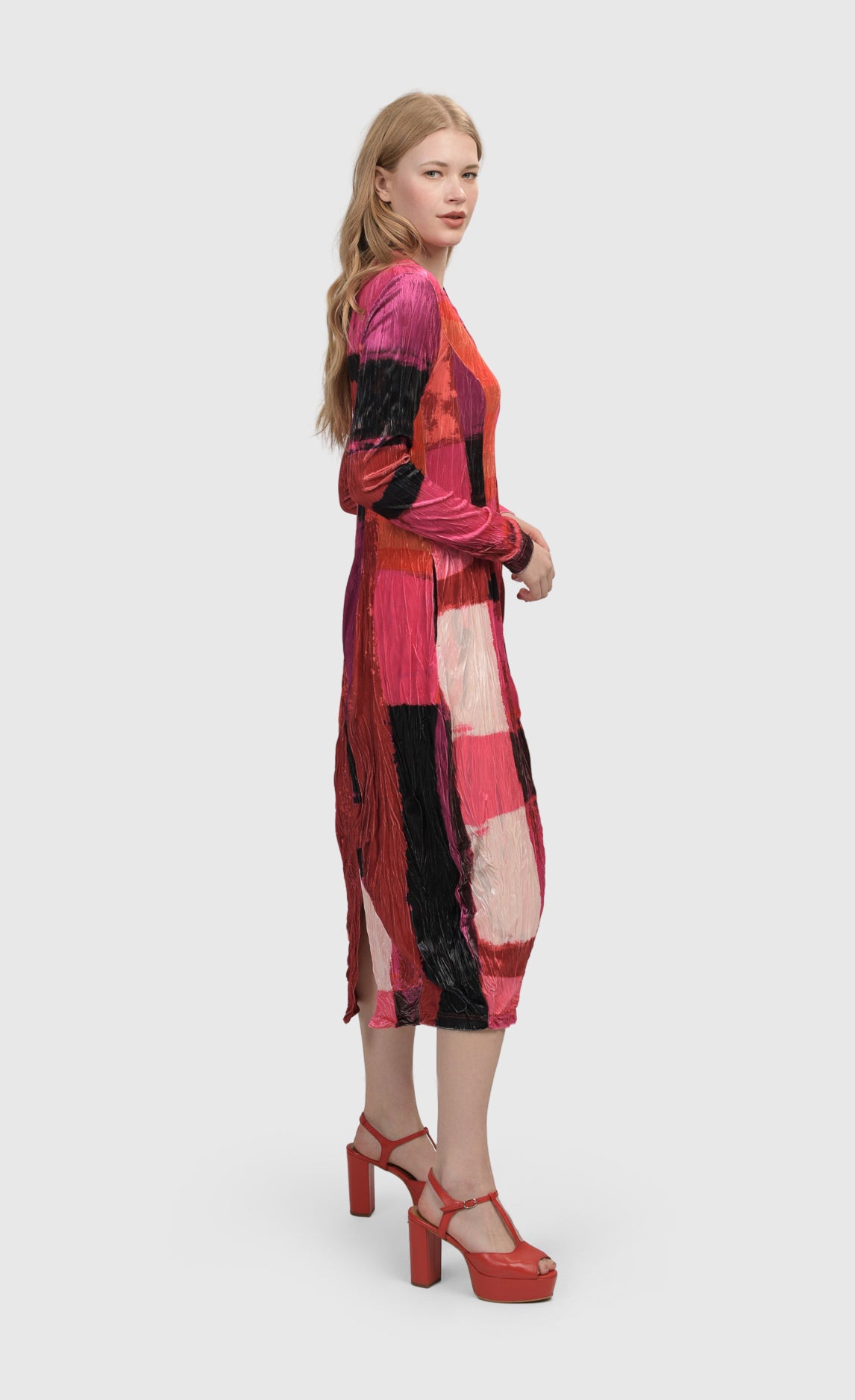 Right side full body view of a woman wearing the Alembika Sunset Strip Cocoon Magenta Dress
