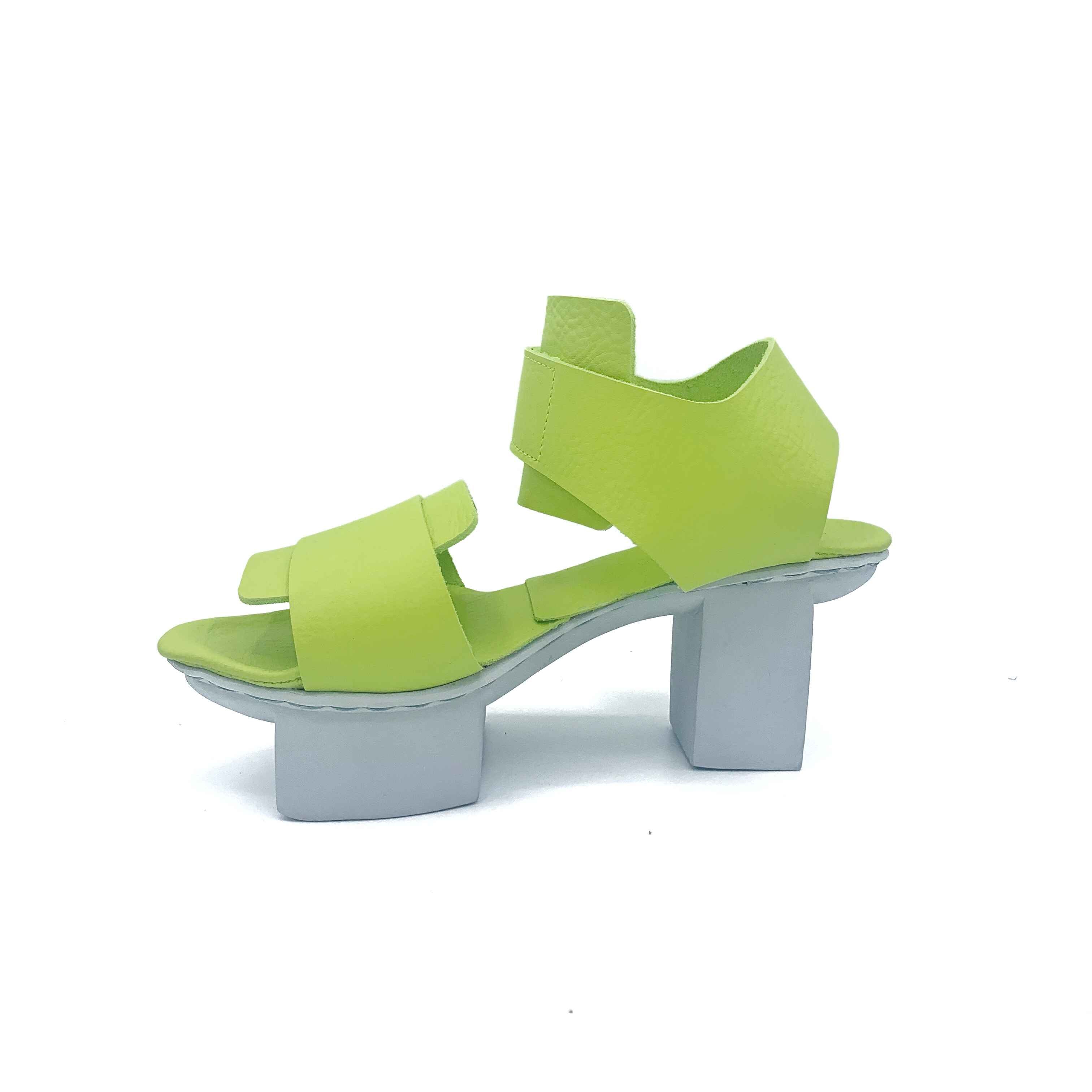 Inner side view of the trippen visor shoe in the color lime with a white sole.