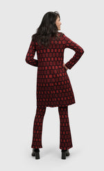 Load image into Gallery viewer, Back full body view of a woman wearing the Alembika Dynamite Days Duster Red Coat
