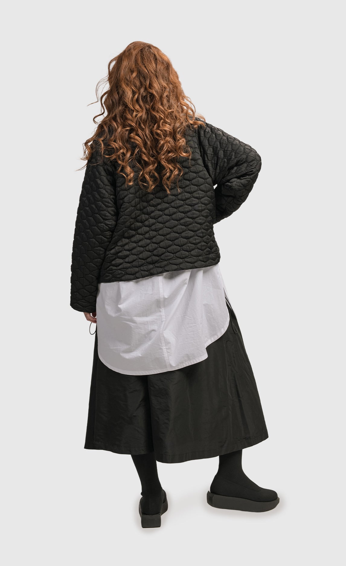 Back full body view of a woman wearing the Alembika Urban Soft Punk Jacket