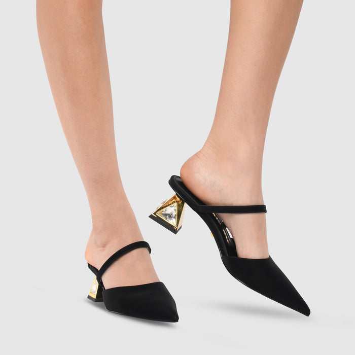 Outer and inner side view of a model wearing a pair of the kat maconie aisha pump in black/gold