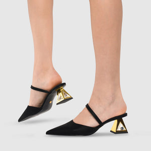 Outer and inner side view of a model wearing a pair of the kat maconie aisha pump in black/gold