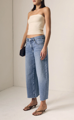 Load image into Gallery viewer, Woman wearing a strapless top and wide-leg jeans against a plain background
