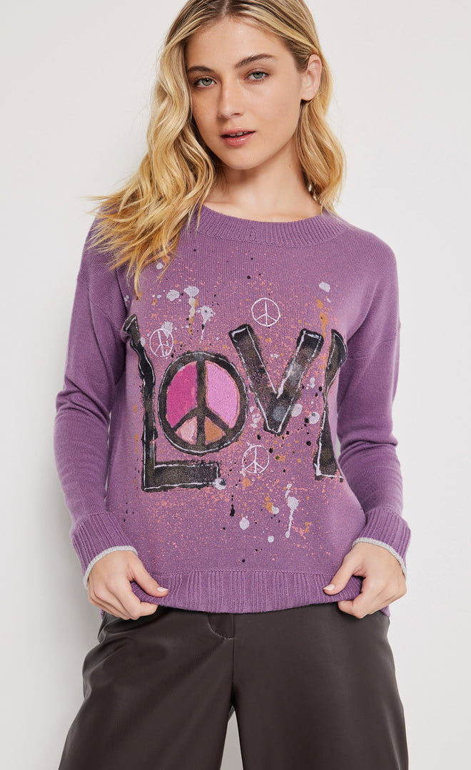 Front top half view of a woman wearing the lisa todd found love pullover