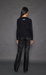 Load image into Gallery viewer, Back full body view of a woman wearing the lisa todd keep em guessing sweater in black.
