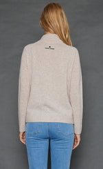 Load image into Gallery viewer, Back top half view of a woman wearing the lisa todd lucky U sweater in oat.
