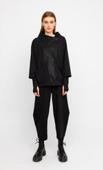 Load image into Gallery viewer, Front full body view of a woman wearing the ozai n ku black cardigan.
