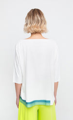 Load image into Gallery viewer, Back top half view of a woman wearing the ozai n ku lagoon boxy tee.
