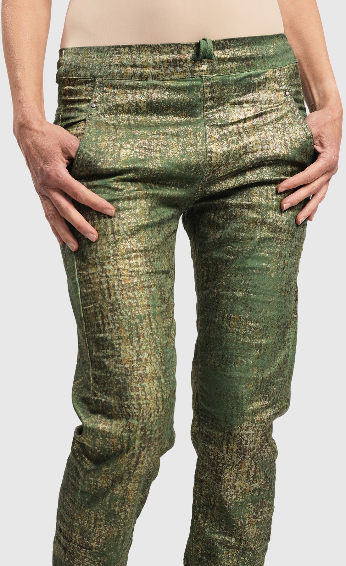 Front close up view of a woman wearing the Alembika Green Iconic Jeans Desires