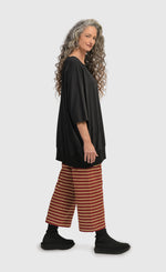Load image into Gallery viewer, Right side view of a woman wearing the Alembika Urban Red Striped Pant
