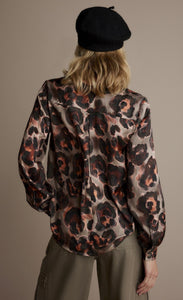 Back top half view of a woman wearing the v-neck animal print top.
