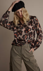 Load image into Gallery viewer, Front top half view of a woman wearing the v-neck animal print top.
