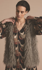 Load image into Gallery viewer, Front top half view of a woman wearing the summum faux fur gilet in clay.
